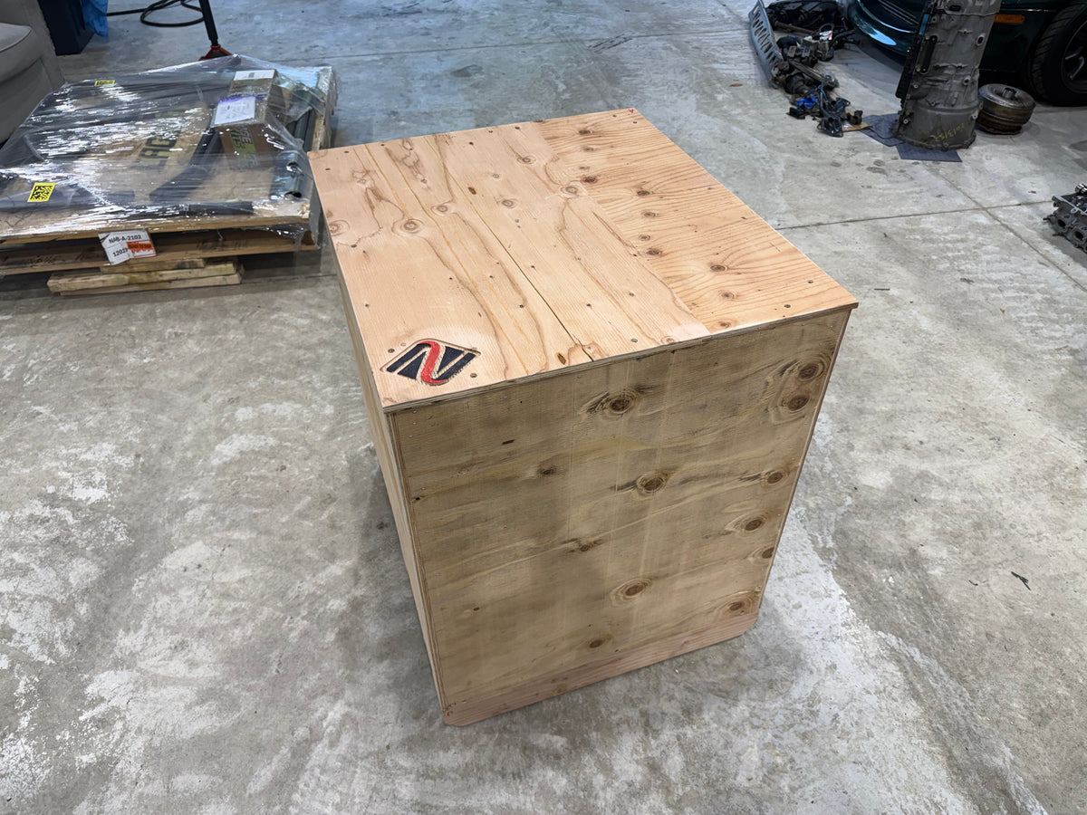 Closed wooden engine shipping crate with the Napp Motorsports logo